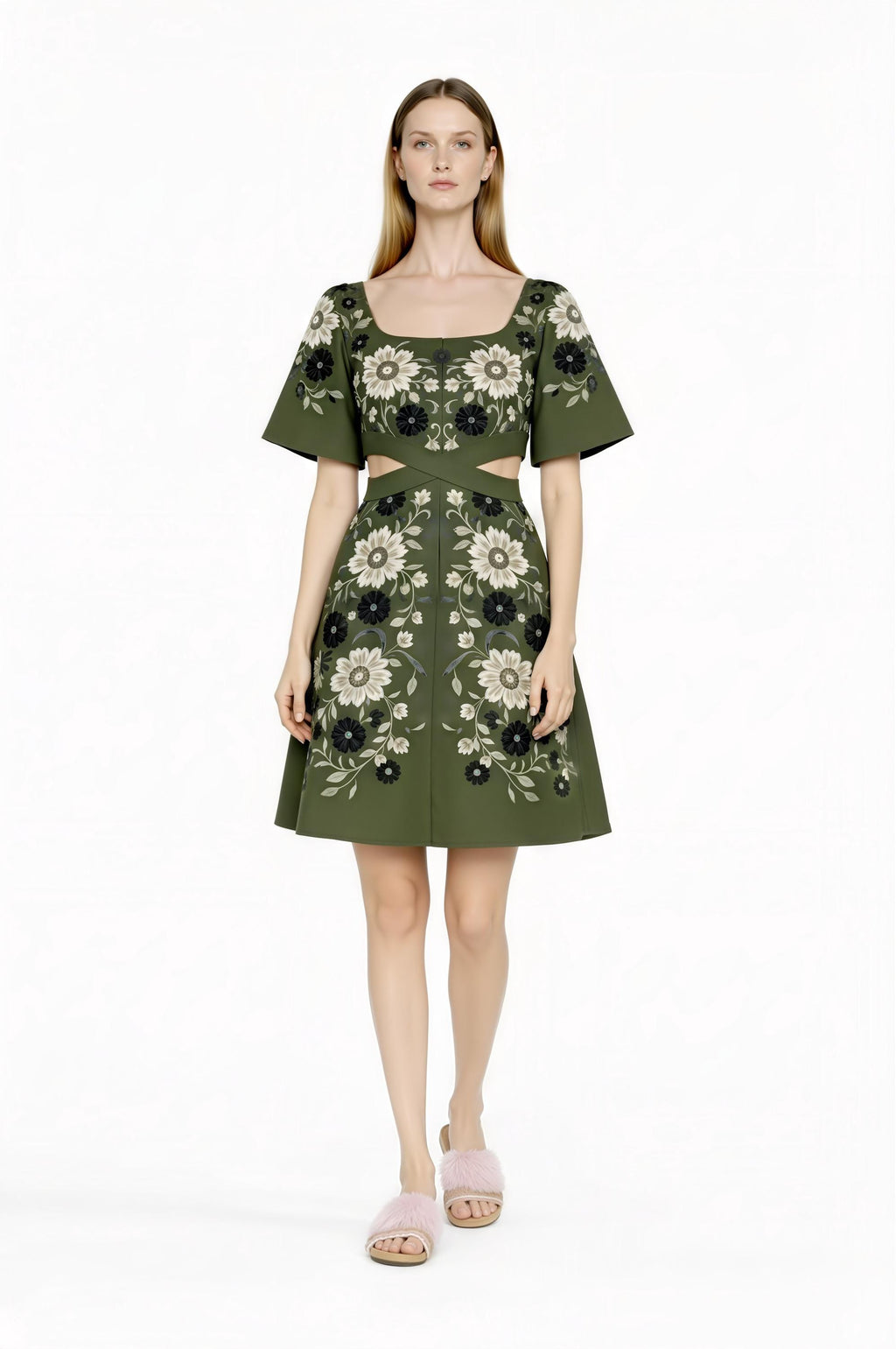 May include: Olive green dress with a square neckline and short sleeves. The dress features a floral pattern in black and white. The waist has a cut-out design. The model is wearing pink fuzzy slippers.
