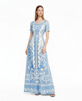 May include: A light blue maxi dress with a white floral pattern. The dress features short sleeves, a round neckline, and a fitted waist. The floral design is repeated throughout the dress, creating a cohesive and elegant look. The dress is floor-length. __etsy:7937371990