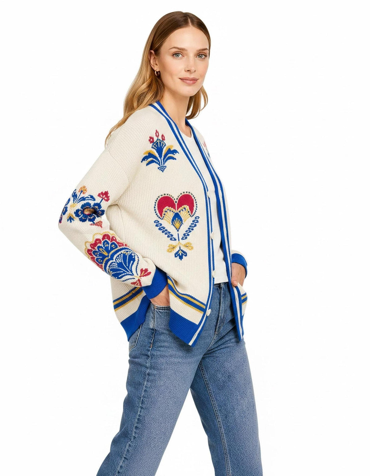 A side-angle view of the ivory knit cardigan with blue trim, showing detailed patterned sleeves and blue cuffs.