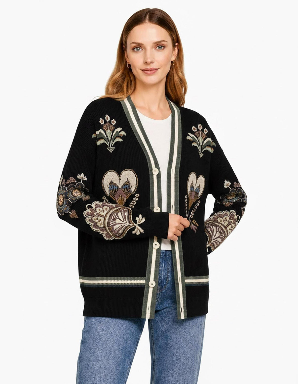 A front view of the black knit cardigan with the model holding the lapel, showing the full patterned front and button closure.