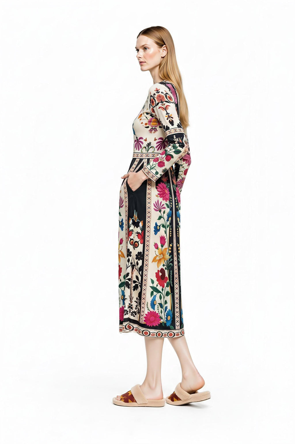 A model from the back right three-quarters angle displaying the back view of the patterned midi dress and her hand in the pocket.