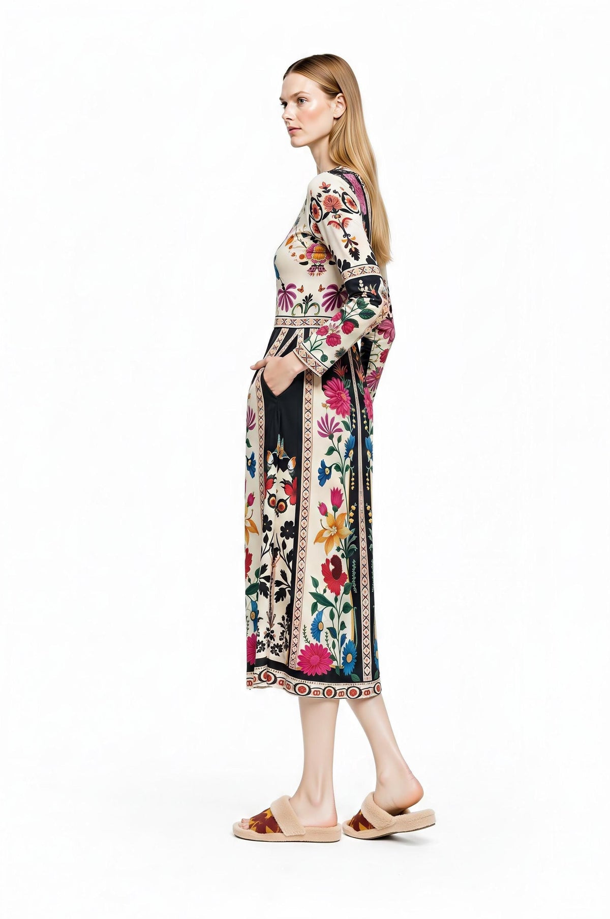A model from the back right three-quarters angle displaying the back view of the patterned midi dress and her hand in the pocket.