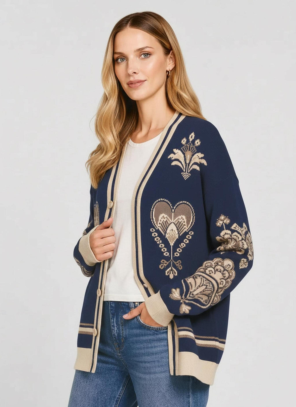 A woman in a dark blue patterned knit cardigan posed with her hand in her pocket, viewed from a slightly turned angle.
